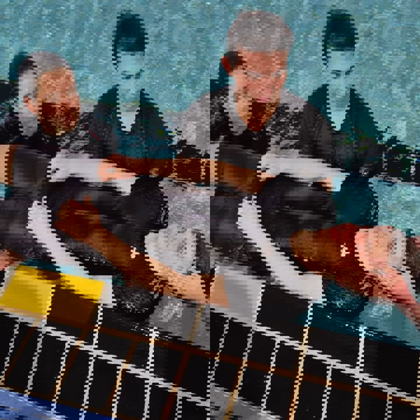 Photo of training of someone being rescued and looked after in a pool environment