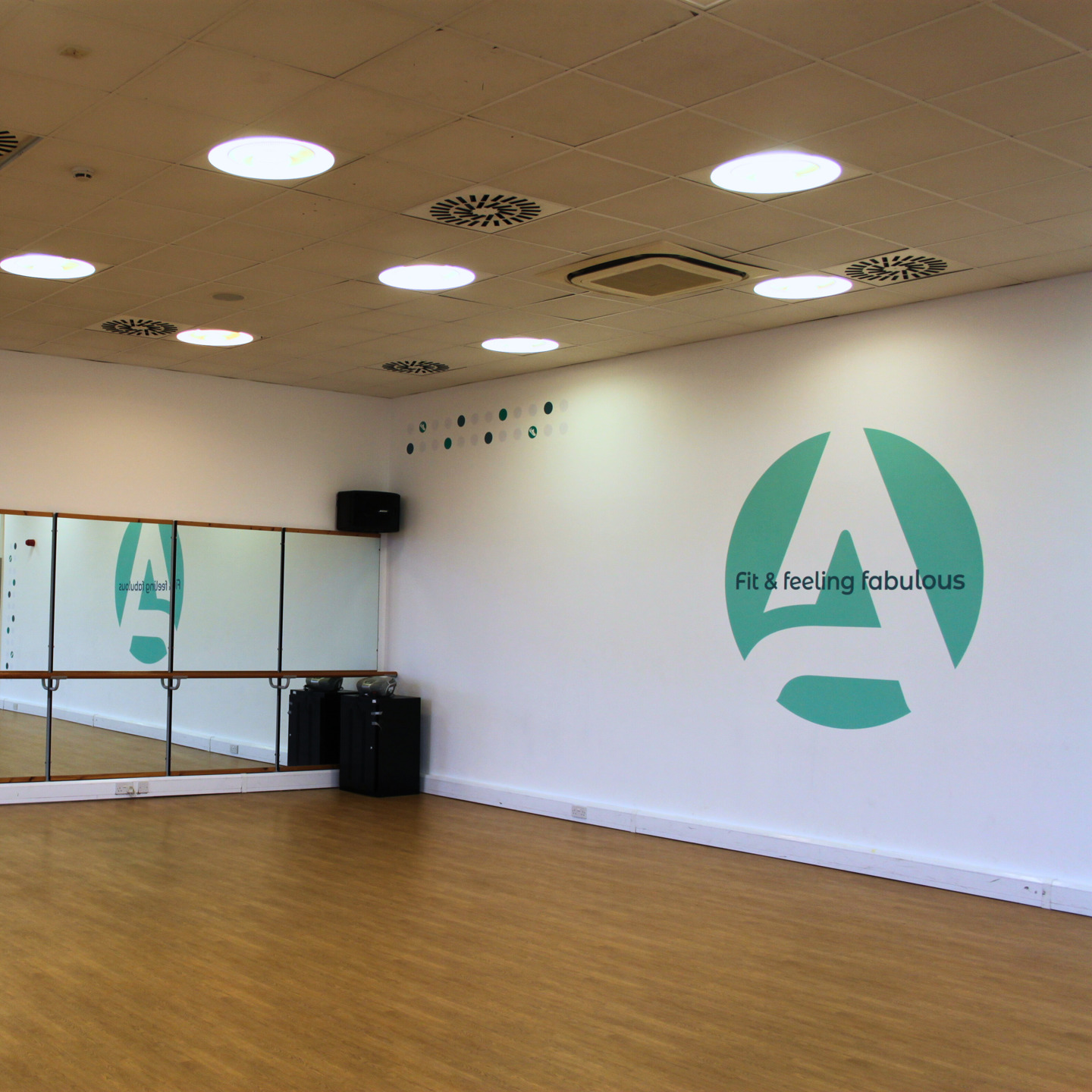 Photo of the Oakfield Dance Studio, showing a light bright room with a wall of mirrors