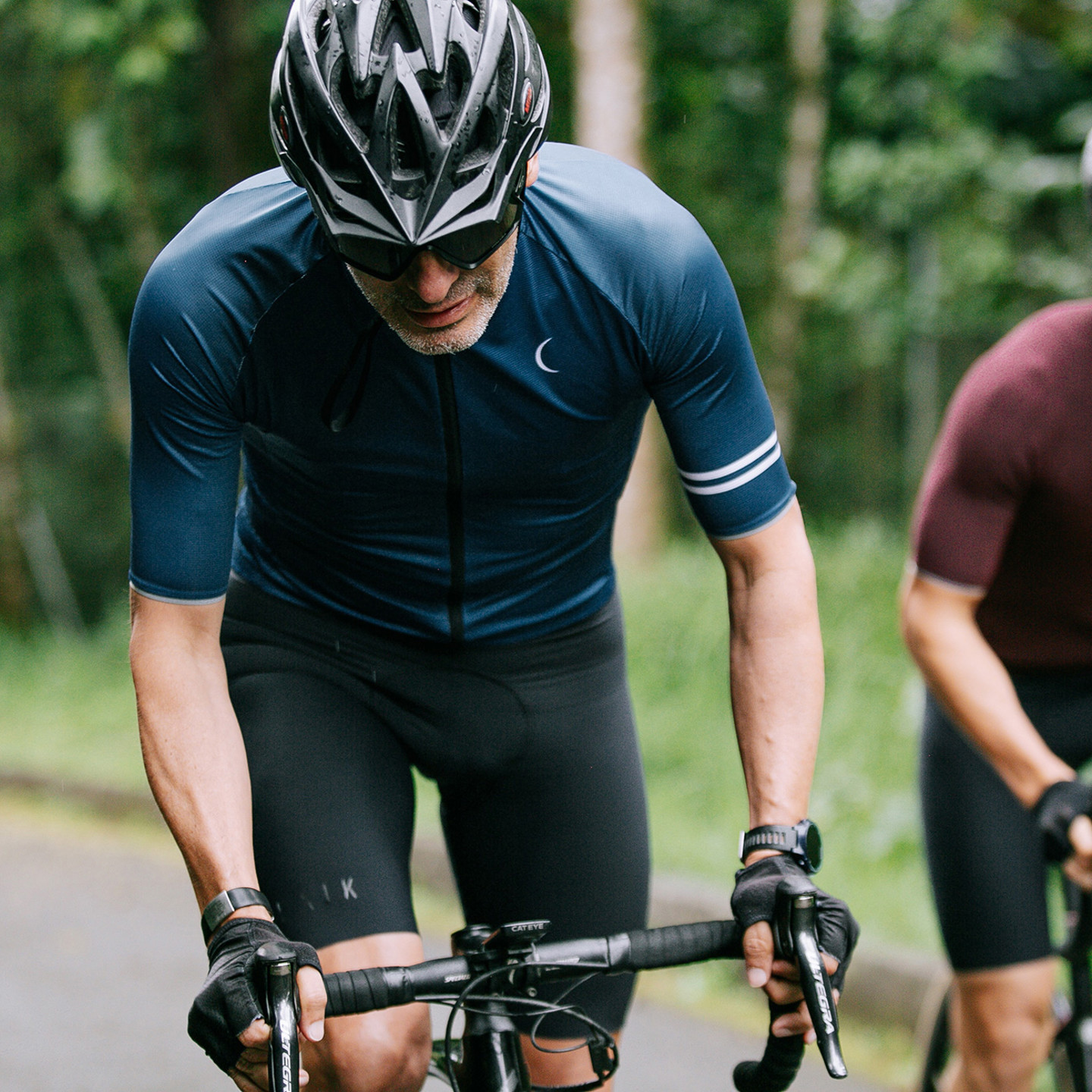 Two men cycling on road