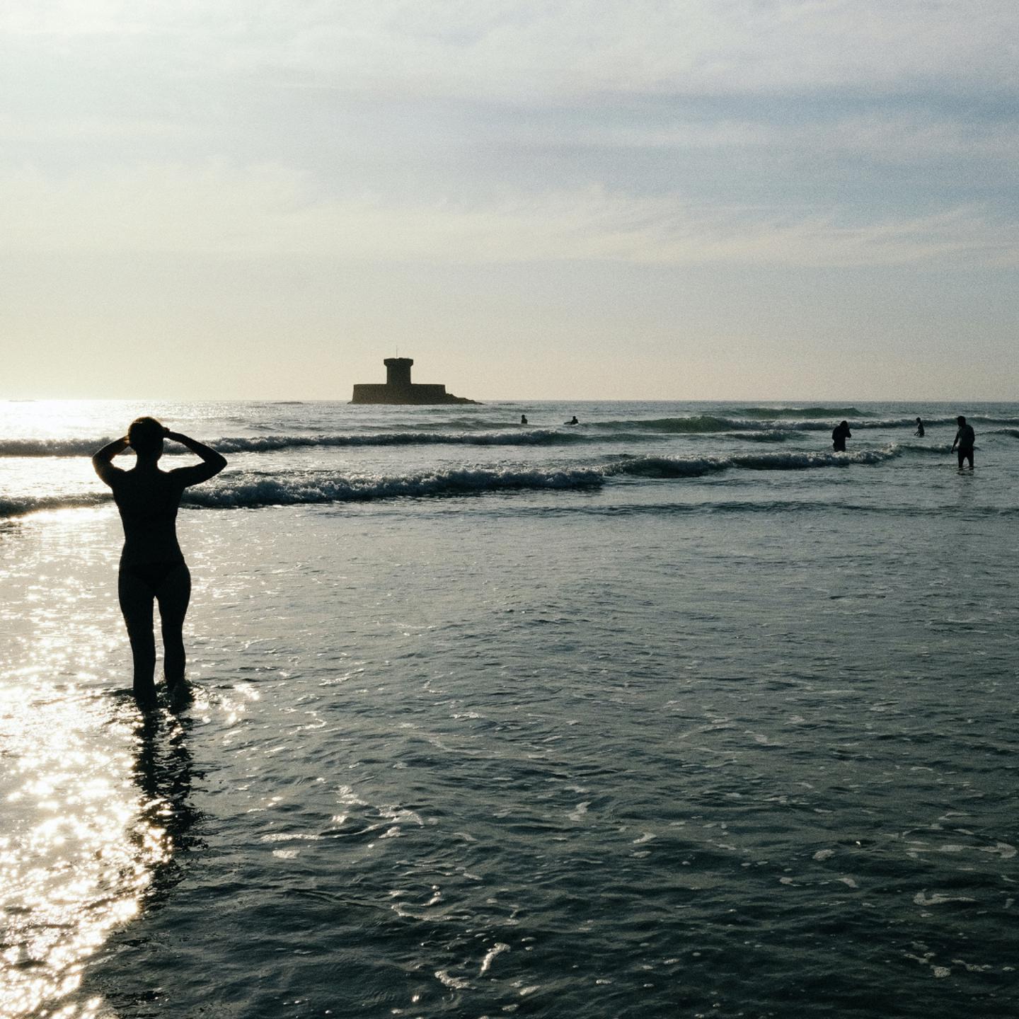People in the sea in Jersey in St Ouen's Bay