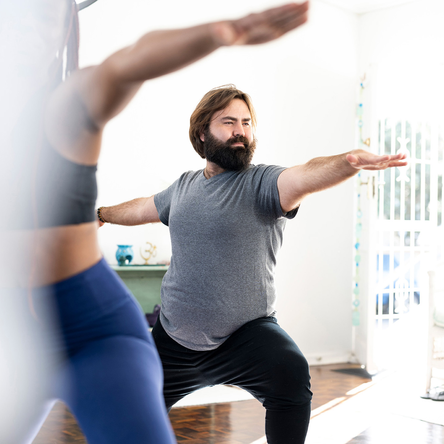 Couple doing yoga inside their home