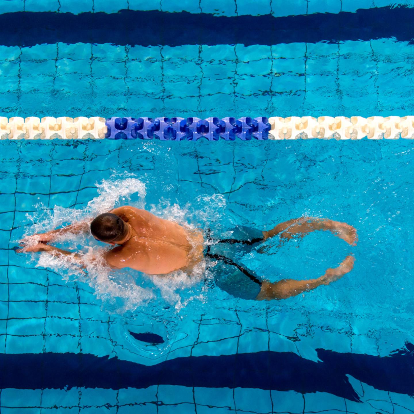 Person lane swimming in swimming pool