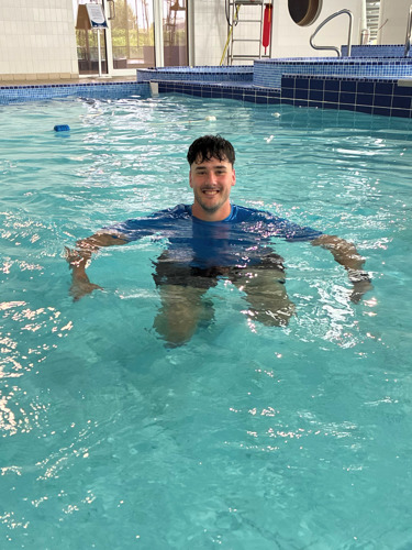 Photo of our Swimming instructor Joe in the swimming pool looking at the camera and smiling