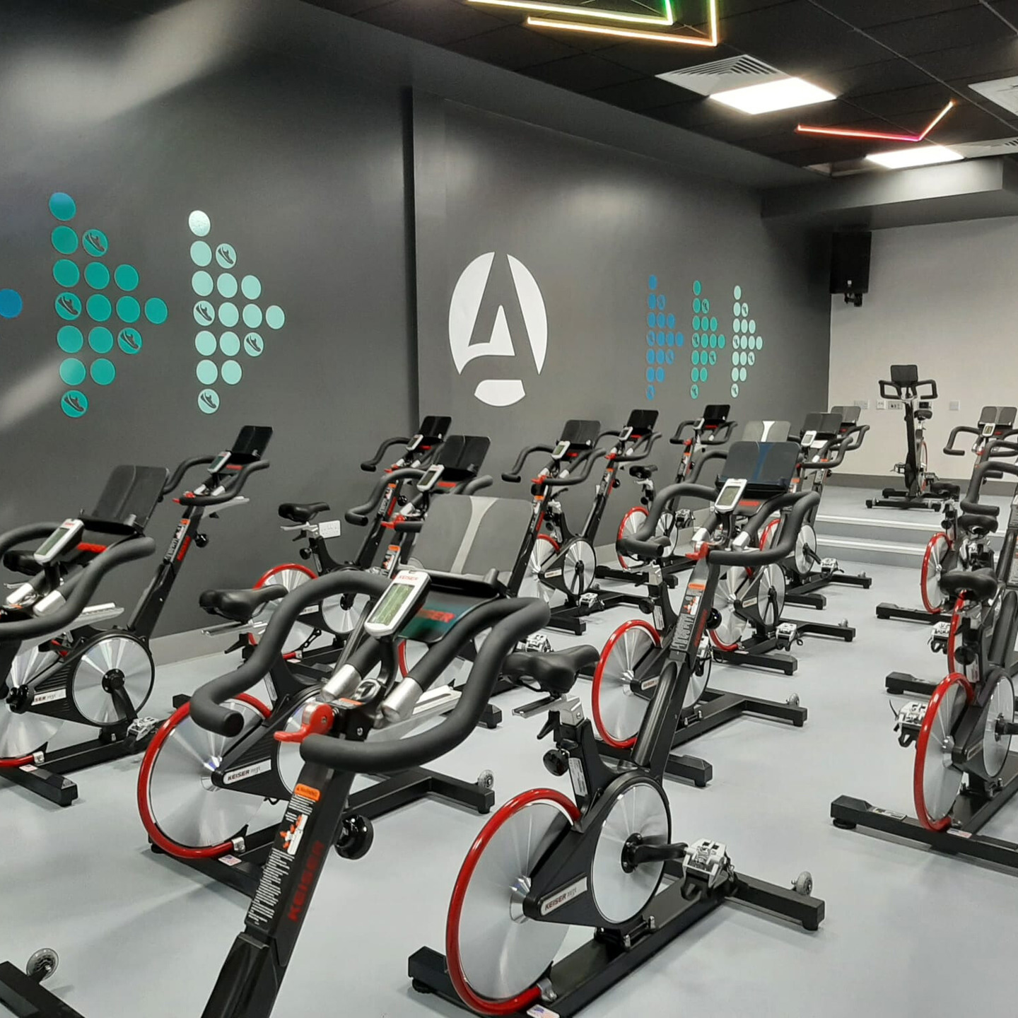 Photograph of the inside of the Spin Studio at Springfield Gym. Several rows of Keiser Spin Bikes shown