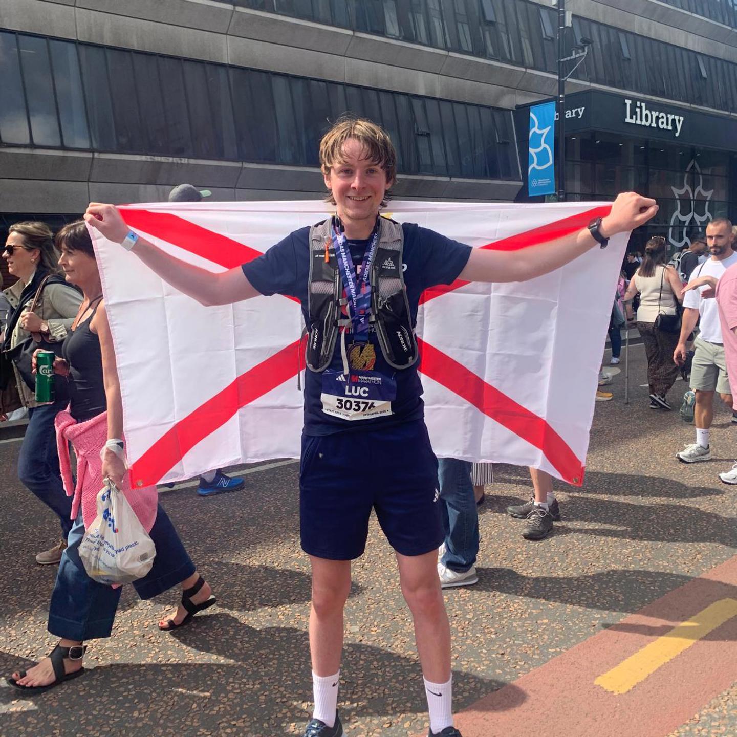 Photo of Luc with the Jersey Flag ahead of taking part in Manchester Marathon