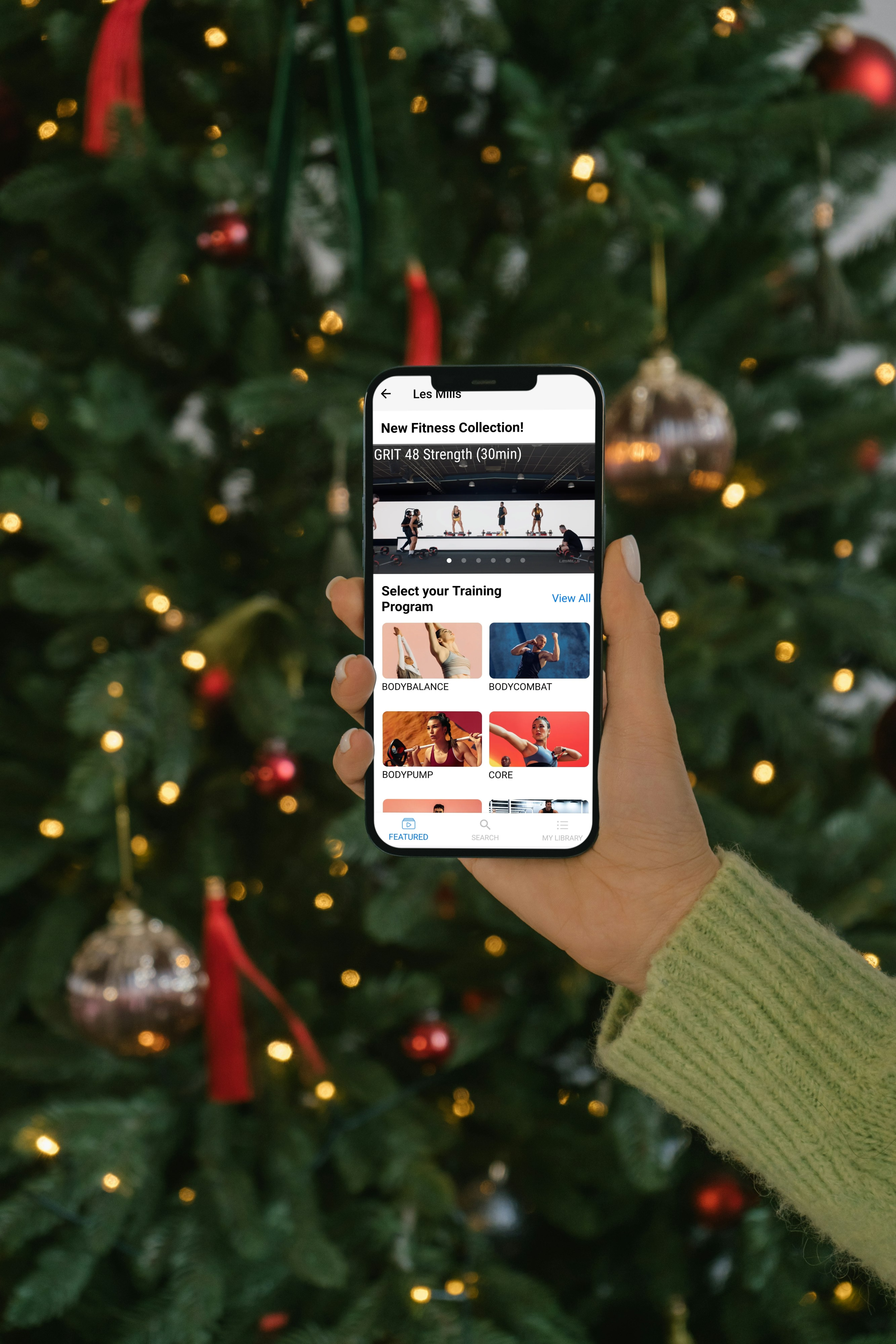 Photo of Les Mills on Demand in front of Christmas tree 