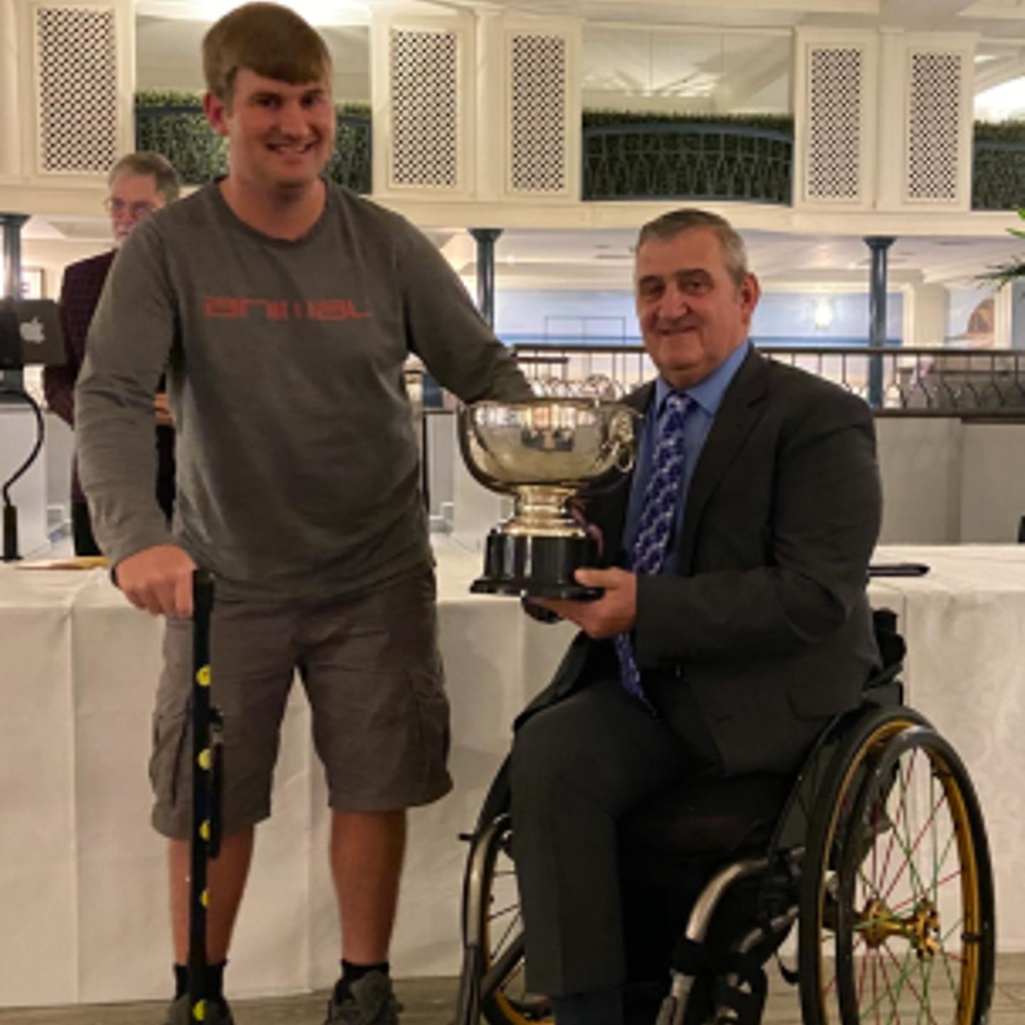 Photo of Ollie being presented with his Wheelchair Person Of The Year award