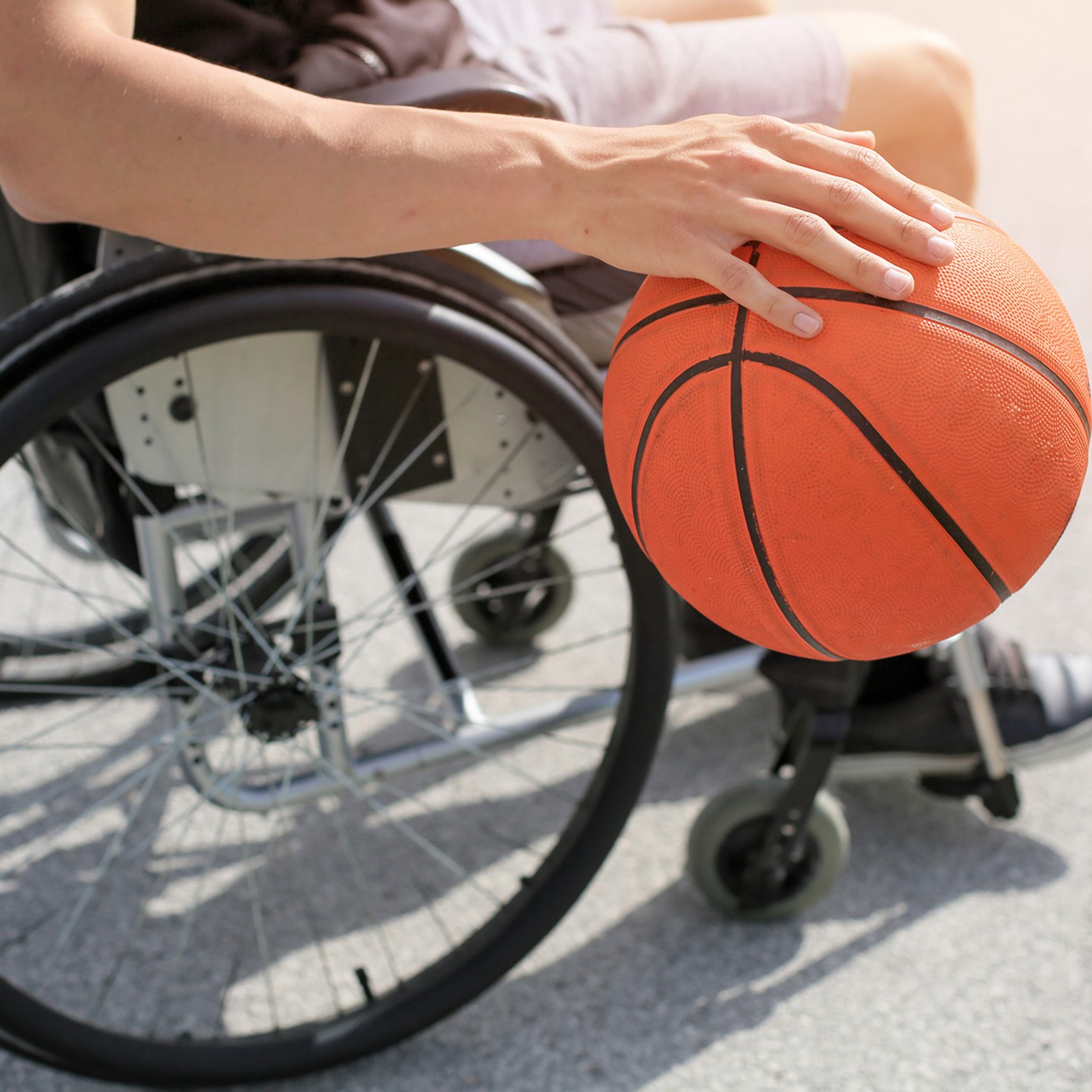 Individual playing basketball whilst in wheelchair