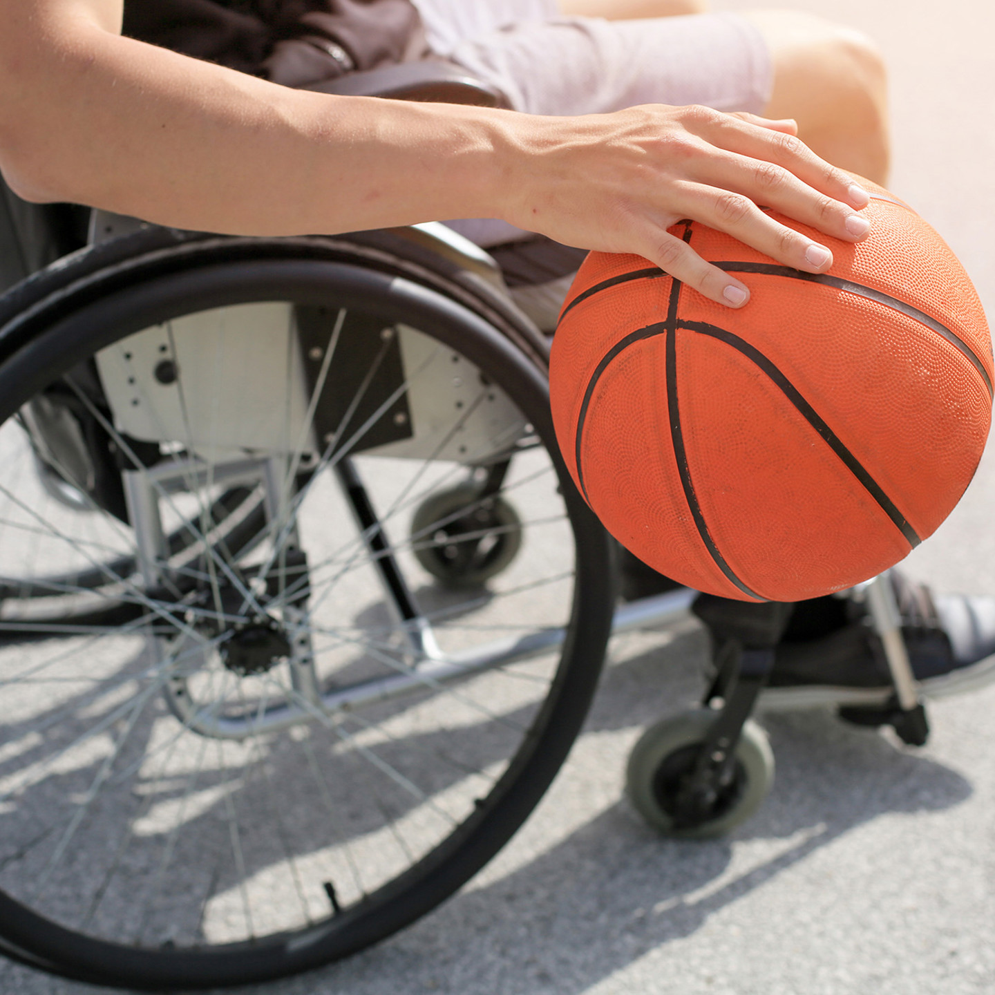 Individual playing basketball whilst in wheelchair