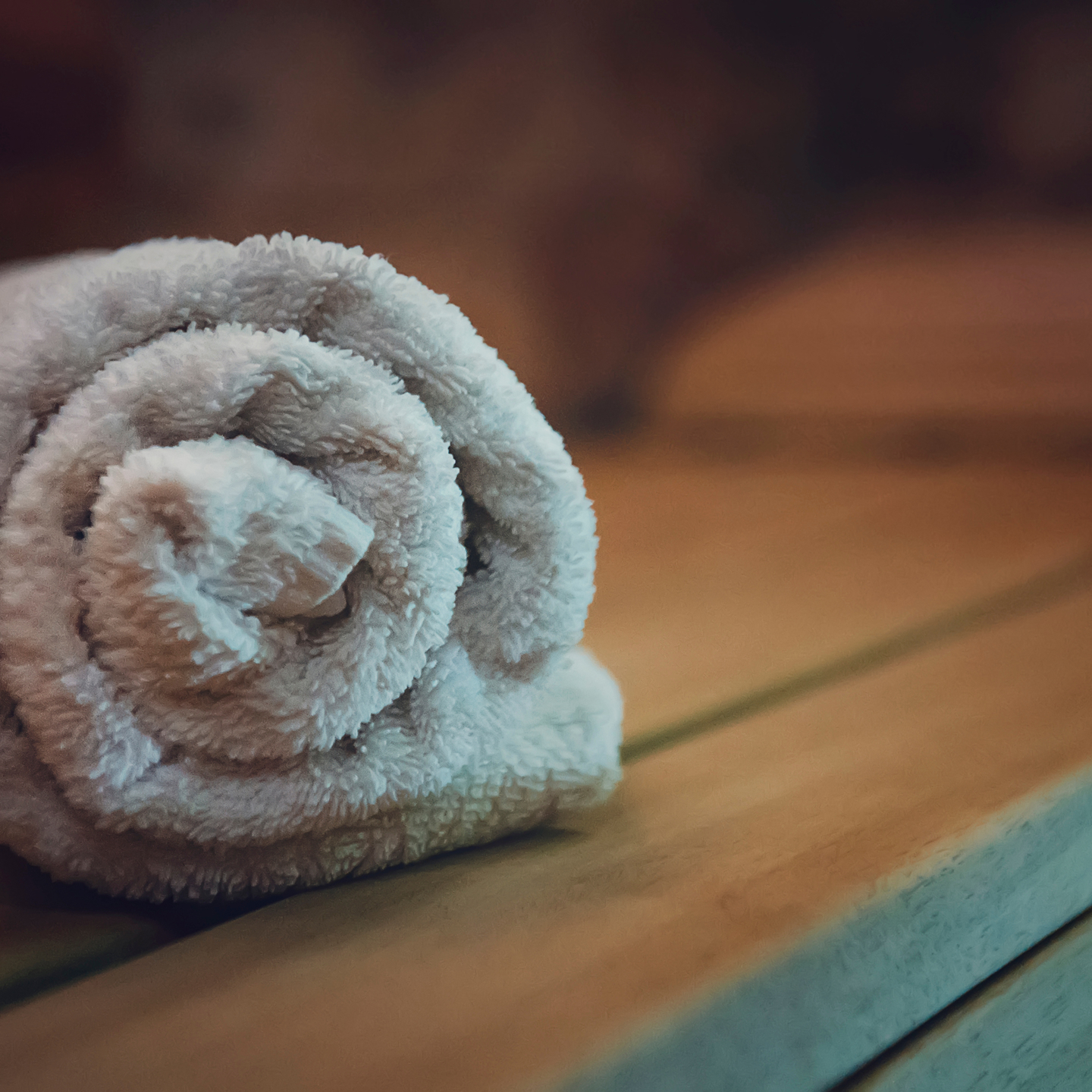 Close up image of a wrapped up towel in a wooden sauna