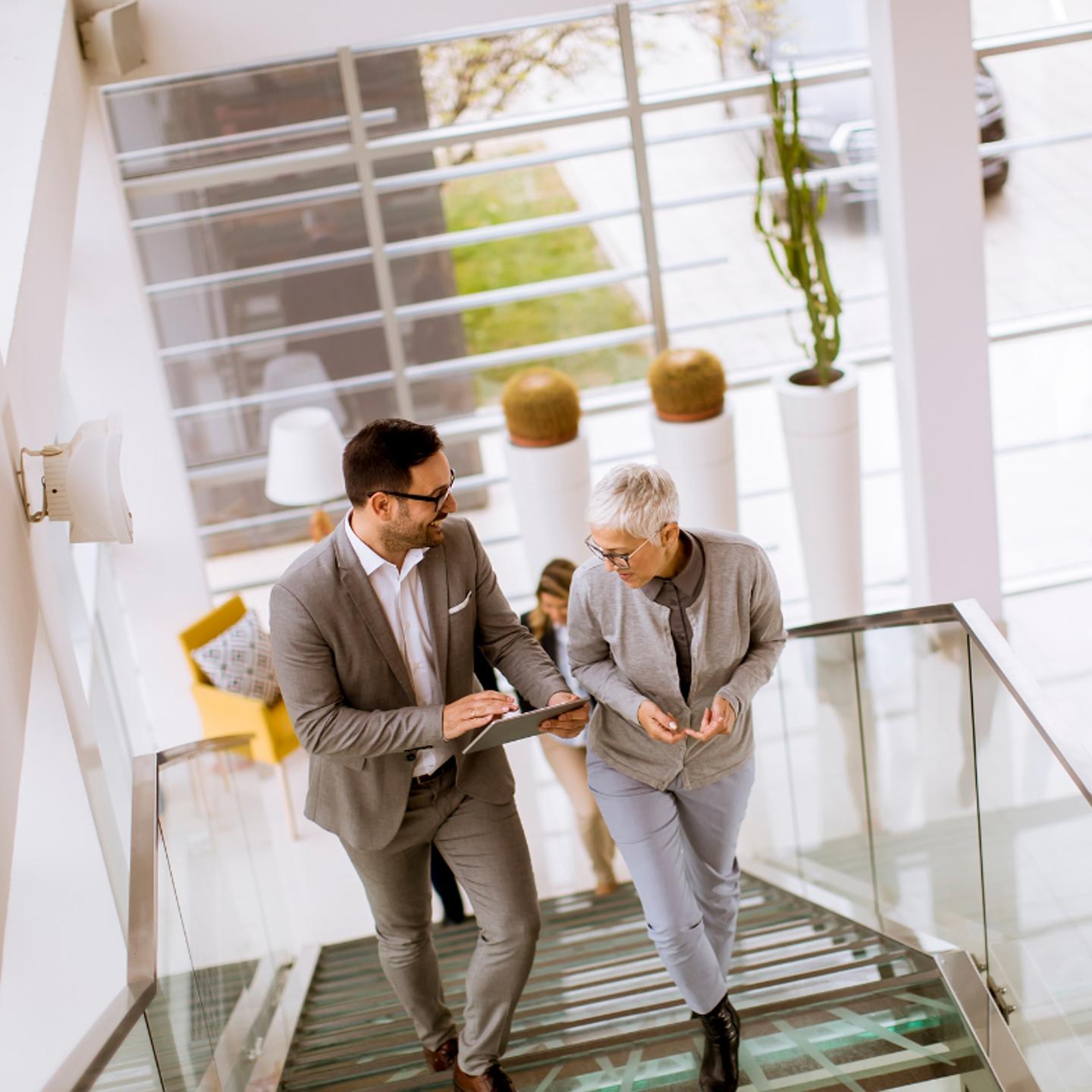 Photo of two people walking upstairs in a gym